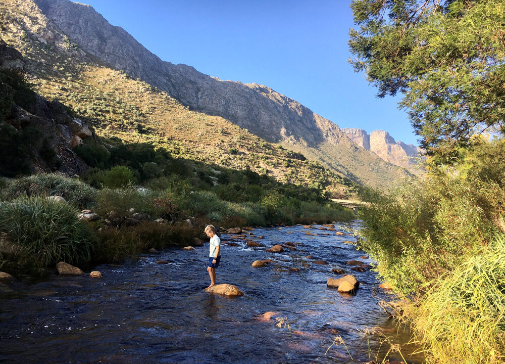 little-boy-on-rock-by-river